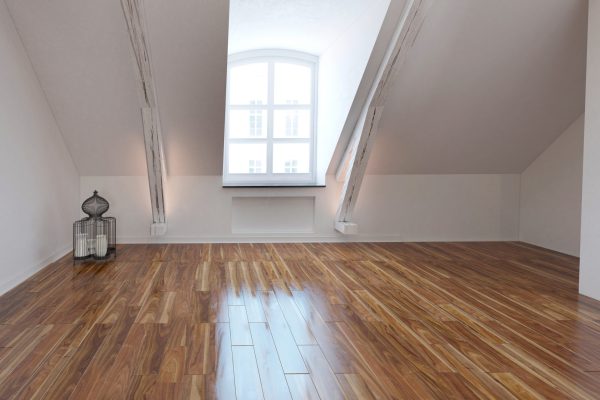 Empty loft room interior with dormer window and a shiny wooden parquet floor with a white sloping wall. 3d Rendering.
